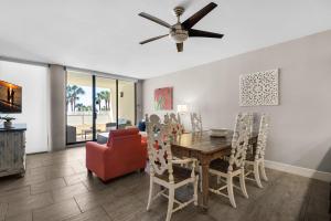 a dining room with a table and chairs and a ceiling fan at East Pass 101 in Destin