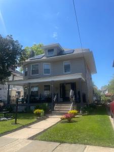 a large house with a porch and stairs to the door at Elizabeth New Jersey bedroom -Newark Airport -New York City in Elizabeth