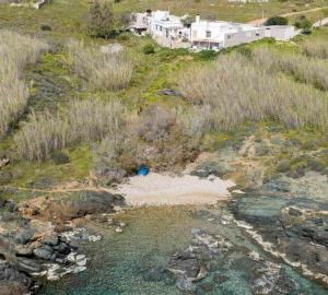 an aerial view of a hill with a river and houses at Smaragda home in Liaropá