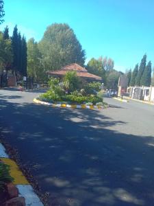 a street with a building with flowers in the middle at Emufuleni river logde in Vanderbijlpark