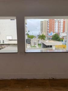 an empty room with a view of a city from a window at Hotel pousada Krone Praia de Iracema Fortaleza in Fortaleza