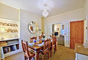 a dining room with a table and chairs at Labernum Cottage, Ingleton Village, Yorkshire Dales National Park, Famous Three Peaks, Near The Lake District, Pets Are Welcome, Direct Parking in front of the Cottage & Guest Parking in Ingleton +30 photos