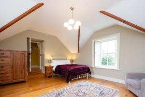 a bedroom with a bed and a window at Historic Luxury House in Corrofin
