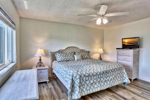 a bedroom with a bed and a ceiling fan at Land's End 4-406 Bay Front in St Pete Beach +52 photos