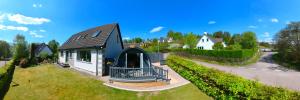 a house with a black roof on a yard at Bonny Wee Snug - Pod in Spean Bridge in Spean Bridge