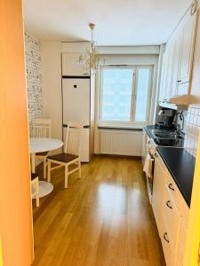 a kitchen with a table and a dining room at Real deal apartments Tampere in Tampere
