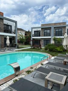 a swimming pool in front of a building at Malta Hotel Bodrum in Bodrum City