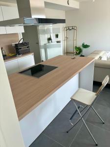 a kitchen with a wooden counter and a chair at Paradis Express - Guillemins Luxury apartment in Liège
