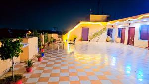 a courtyard of a house at night with lights at Hotel Happy Residency-Sainik Farms in New Delhi