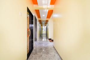 a corridor of a building with orange ceilings at OYO Hotel Boss Lodging in Aurangabad