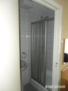a bathroom with a shower and a sink at Hotel 't Anker in Leeuwarden