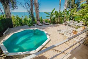 a swimming pool in a backyard with a view of the ocean at Villa Lile in Batumi
