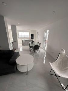 a living room with a couch and a table and chairs at Furna Blue View in Lagoa