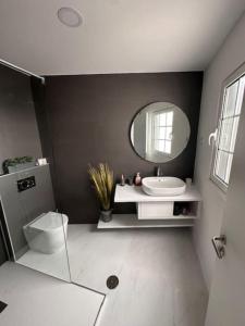 a bathroom with a sink and a mirror at Furna Blue View in Lagoa +34 photos
