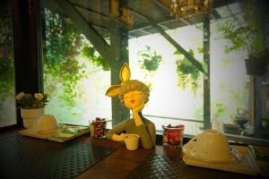 a figurine of a woman sitting on a table at Ban Mai Vintage in Pak Chong