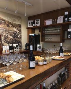 a bar with wine bottles and glasses on a counter at Apartamentos Calm & Nature - Adults Only in Cabezón de Liébana
