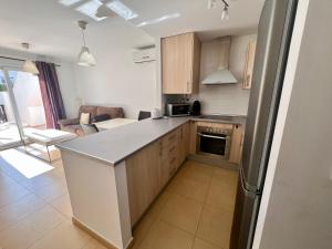 a kitchen with a counter top and a refrigerator at Condado de Alhama, NARANJOS 7 SV55 in La Molata +6 photos
