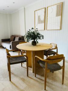 a table with a vase of flowers on it in a living room at La Gavina Loft Xàbia in Jávea