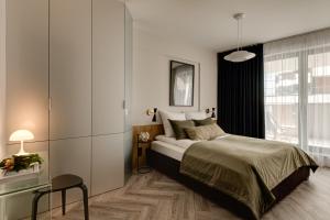 Posteľ alebo postele v izbe v ubytovaní Sage Apartment