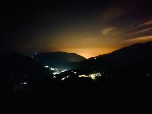 a sunset in the mountains with the lights on at Junyi Landscape Villa in Ren'ai