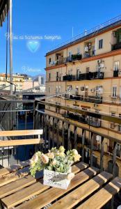 a bouquet of flowers on a table on a balcony at Mazzocchi House welcome wine in Naples