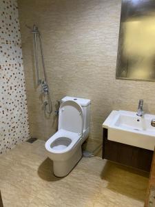 a bathroom with a toilet and a sink at KLCC View by Regalia Dorms in Kuala Lumpur