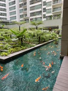 a swimming pool in a building with kites in the water at KLCC View by Regalia Dorms in Kuala Lumpur +10 photos