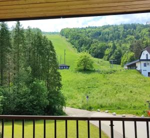 a view of a green field from a balcony at Villa Mari I in Maribor