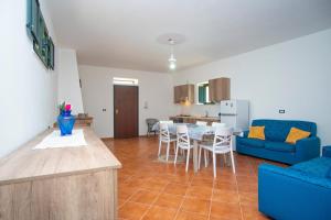 a living room with a blue couch and a table at La Dolce Vita in Camerota +9 photos