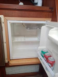 an open refrigerator with two cans of soda in it at Velero Valencia Whimsy in Valencia