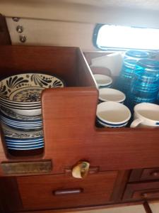 a drawer with plates and bowls in a cabinet at Velero Valencia Whimsy in Valencia