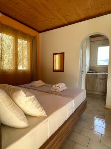 a large bed in a room with a bathroom at Aroma Studios in Argostoli