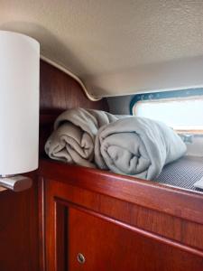 a blanket laying on a shelf in a boat at Velero Valencia Whimsy in Valencia