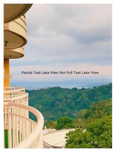 a view of a mountain from a building at Cityland Janna's Family Suite Full Taal Lake View & Studio Partial Taal Lake View or City View Free Pool, Parking, Wifi, and View Deck in Tagaytay