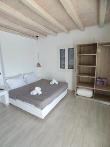 a bedroom with a bed with two towels on it at Ftelia Breeze in Klouvas +63 photos