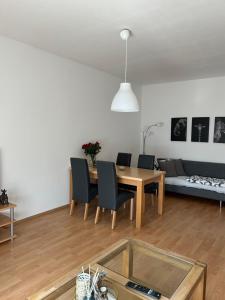 a living room with a table and chairs and a couch at Lidia Apartment in Celle