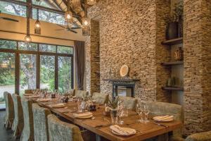 a dining room with a long table and chairs at Abelana Safari Camp in Phalaborwa