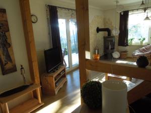 a living room with a television and a kitchen at Ferienhaus für 5 Personen ca 70 qm in Sankt Andreasberg, Harz Oberharz in Sankt Andreasberg