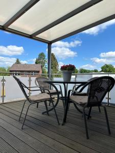 a patio with a table and chairs on a deck at Lidia Apartment in Celle
