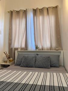a bedroom with a large bed with curtains at CONDO IN LAPU LAPU NEAR AIRPORT in Lapu Lapu City