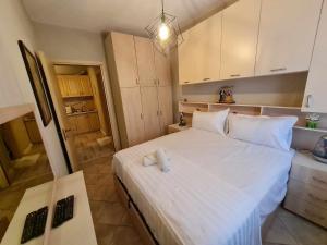 a bedroom with a large white bed in a room at Golem Rajmonda's House in Golem