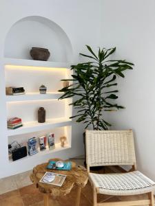 um quarto com uma mesa, uma cadeira e uma planta em Delight Apartments suites em Stelida