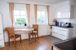 a kitchen with a table and chairs in a room at Ferienhaus Nuova Via in Griffen