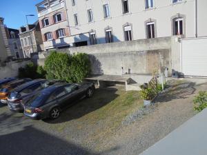 a row of cars parked in front of a building at Hotel De La Gare in Montluçon