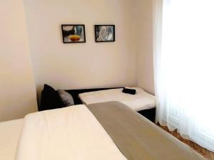 a small room with two beds and a window at Vale in Pirovac