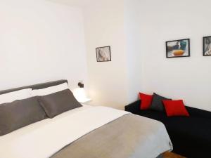 a bedroom with a white bed and red pillows at Vale in Pirovac