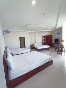 Giường trong phòng chung tại Mangolia Hotel