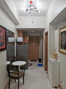 a kitchen and dining room with a table and chairs at Moa shore 3 residence in Manila