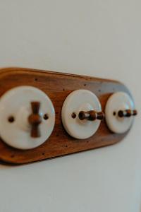 a wooden plate with three donuts with a cross on it at Hotel Mas Rabiol -Costa Brava-Emporda-Only Adults in Peratallada