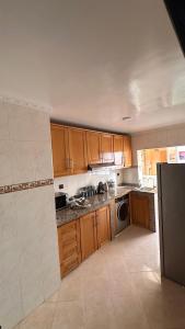 een keuken met houten kasten en een koelkast bij Lapatchi appart in Agadir